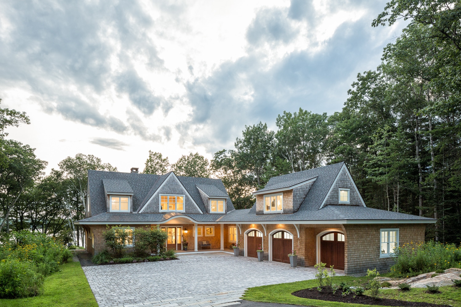 Surrounded by nature this is a classic New England cedar shake style house with a twist.