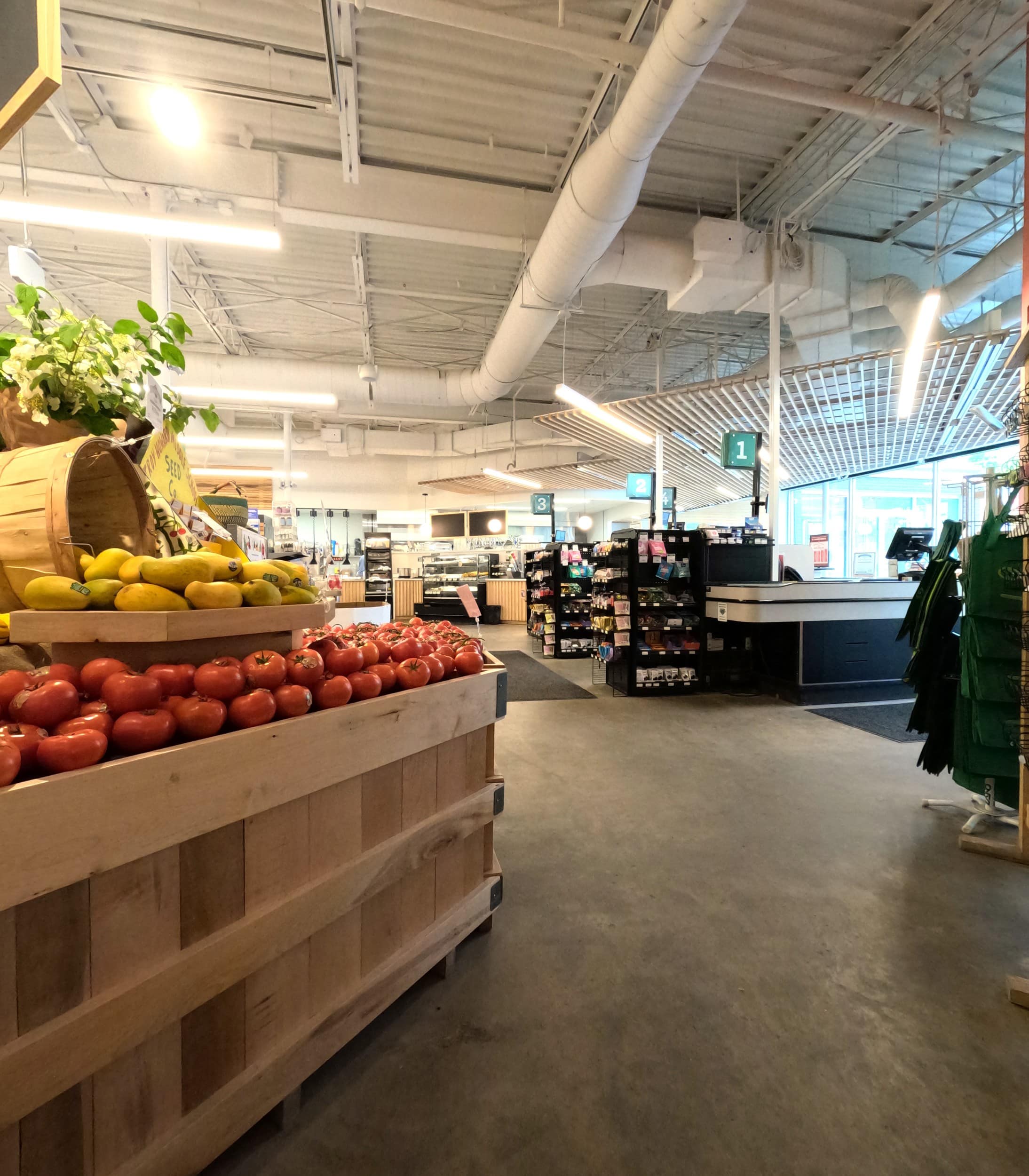 Belfast Community Co-op, produce section of supermarket and check out registers.