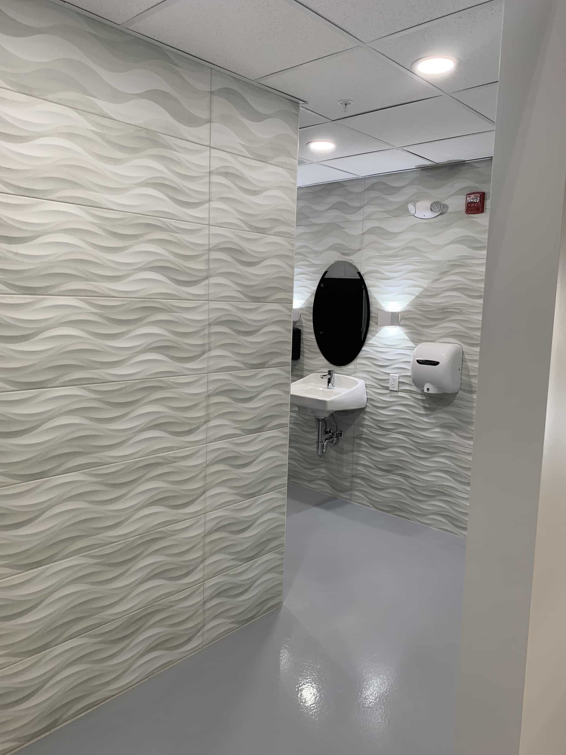 Commercial bathroom with wave wall tiles