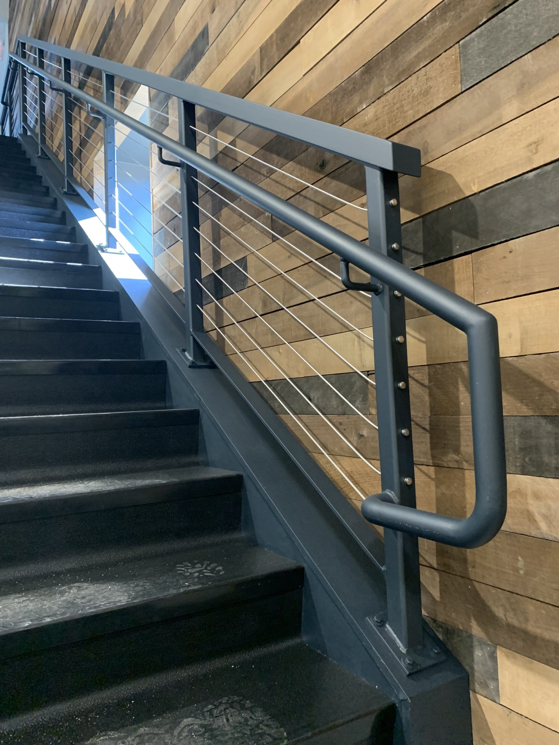 cable rail stairs with decorative wood walls