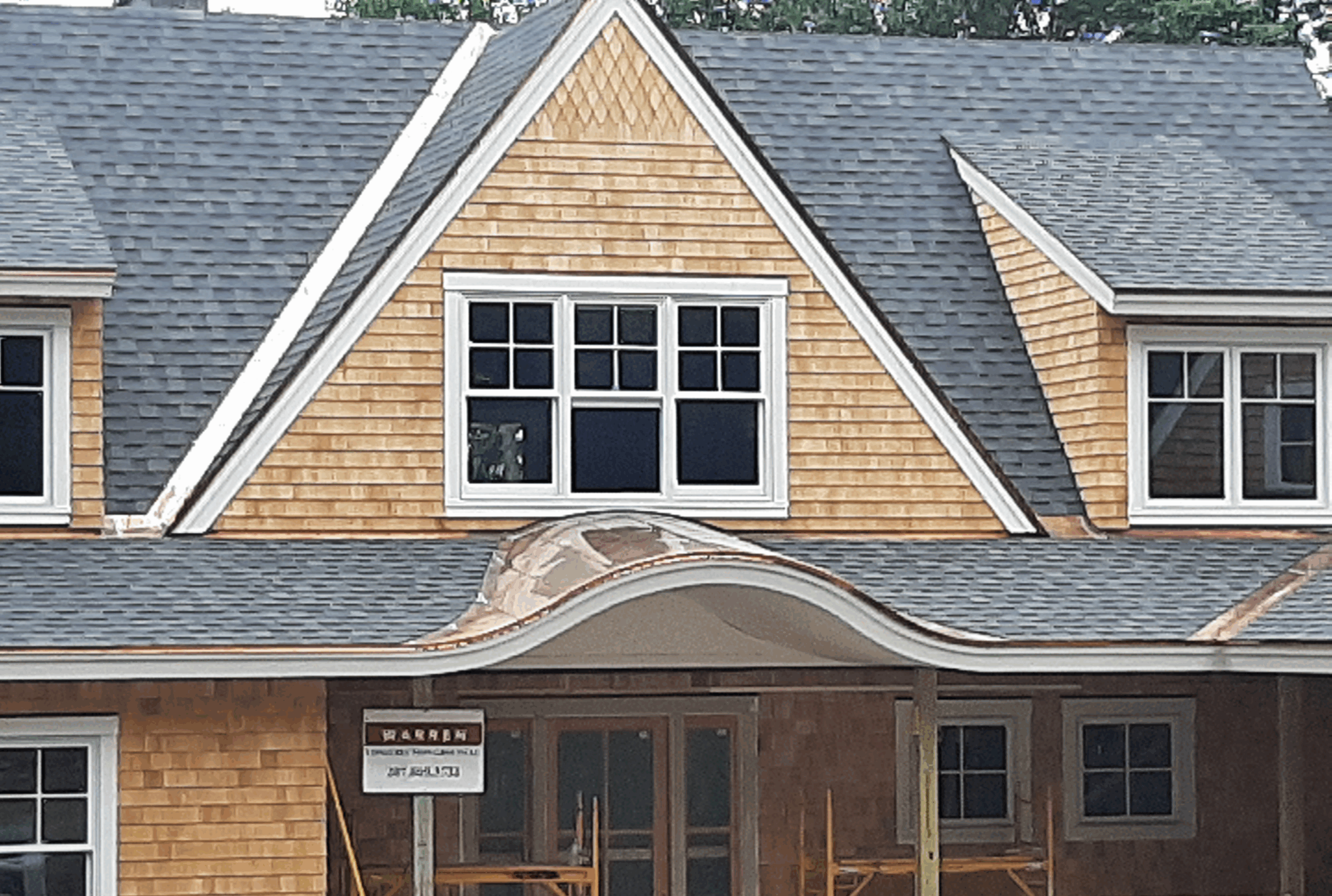 Curved copper roof over house main door