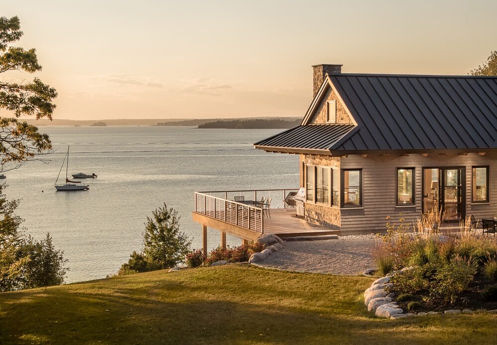 A stunning custom built house sits at the top of a hill overlooking the ocean in Harpswell Maine