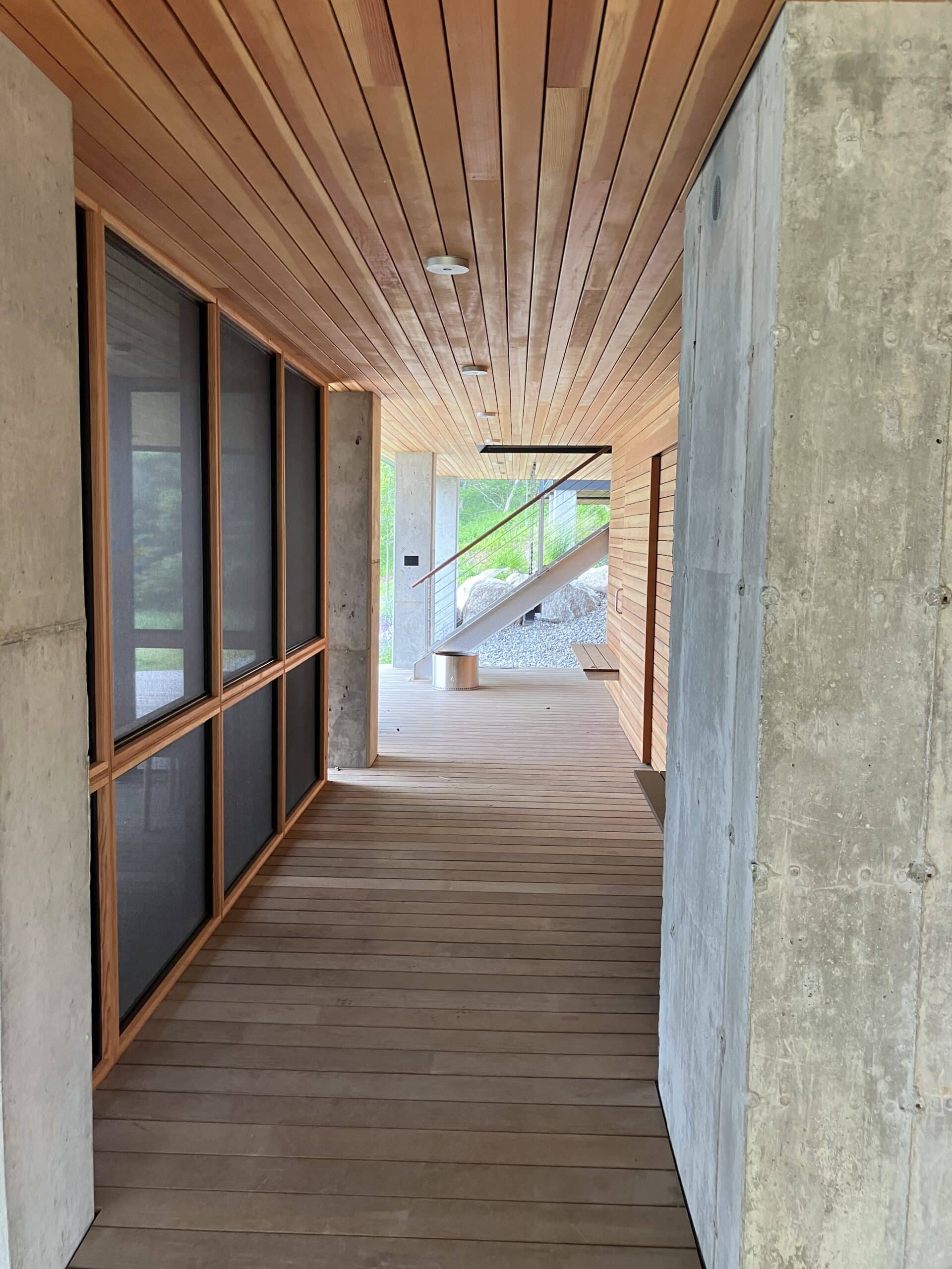 Ipe decking below the house with a custom screen porch. Large concrete piers keep the house above out of any potential flood plain.