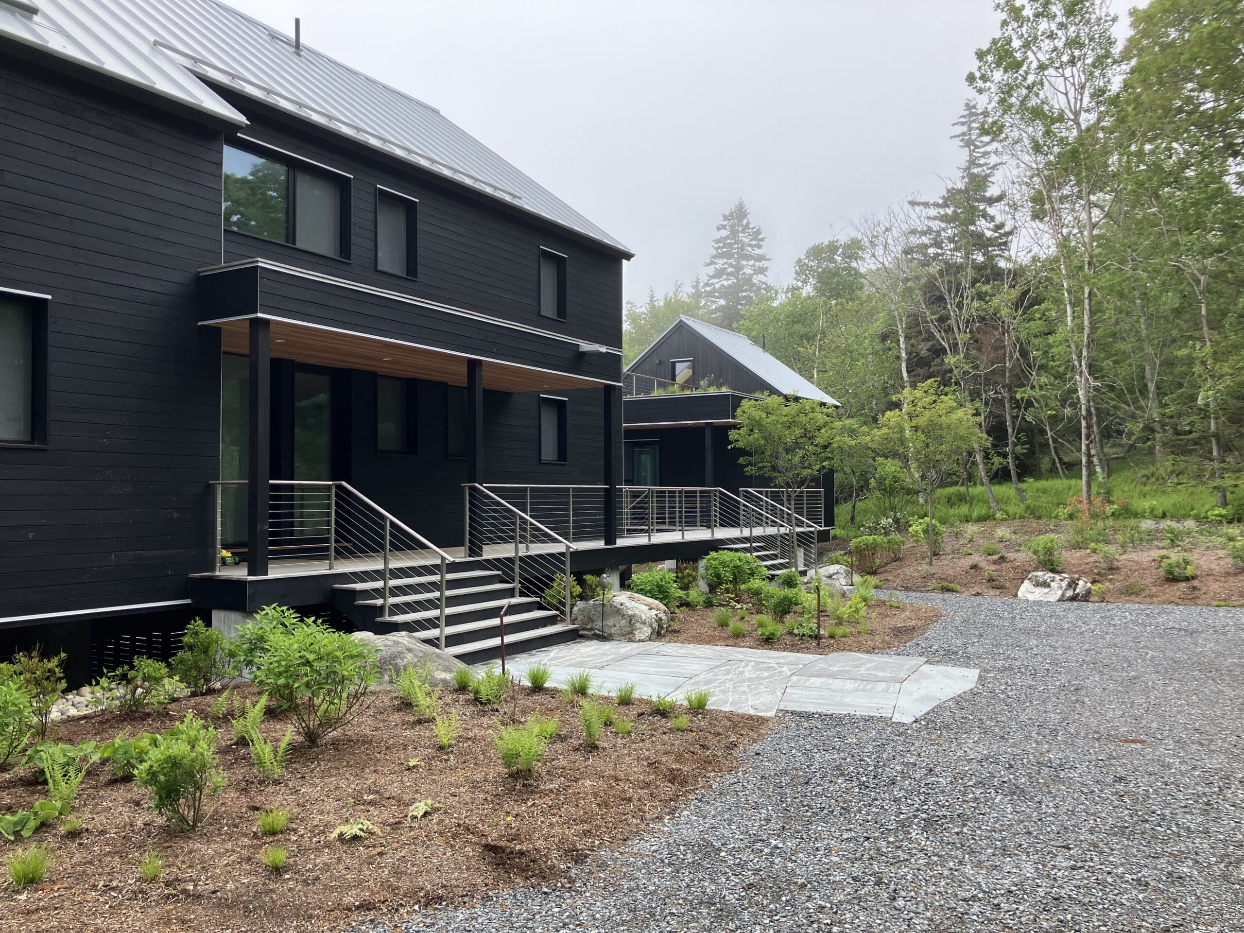 Entrance way onto deck of this modern Bensonwood panelized home and guest house on the coast of Maine