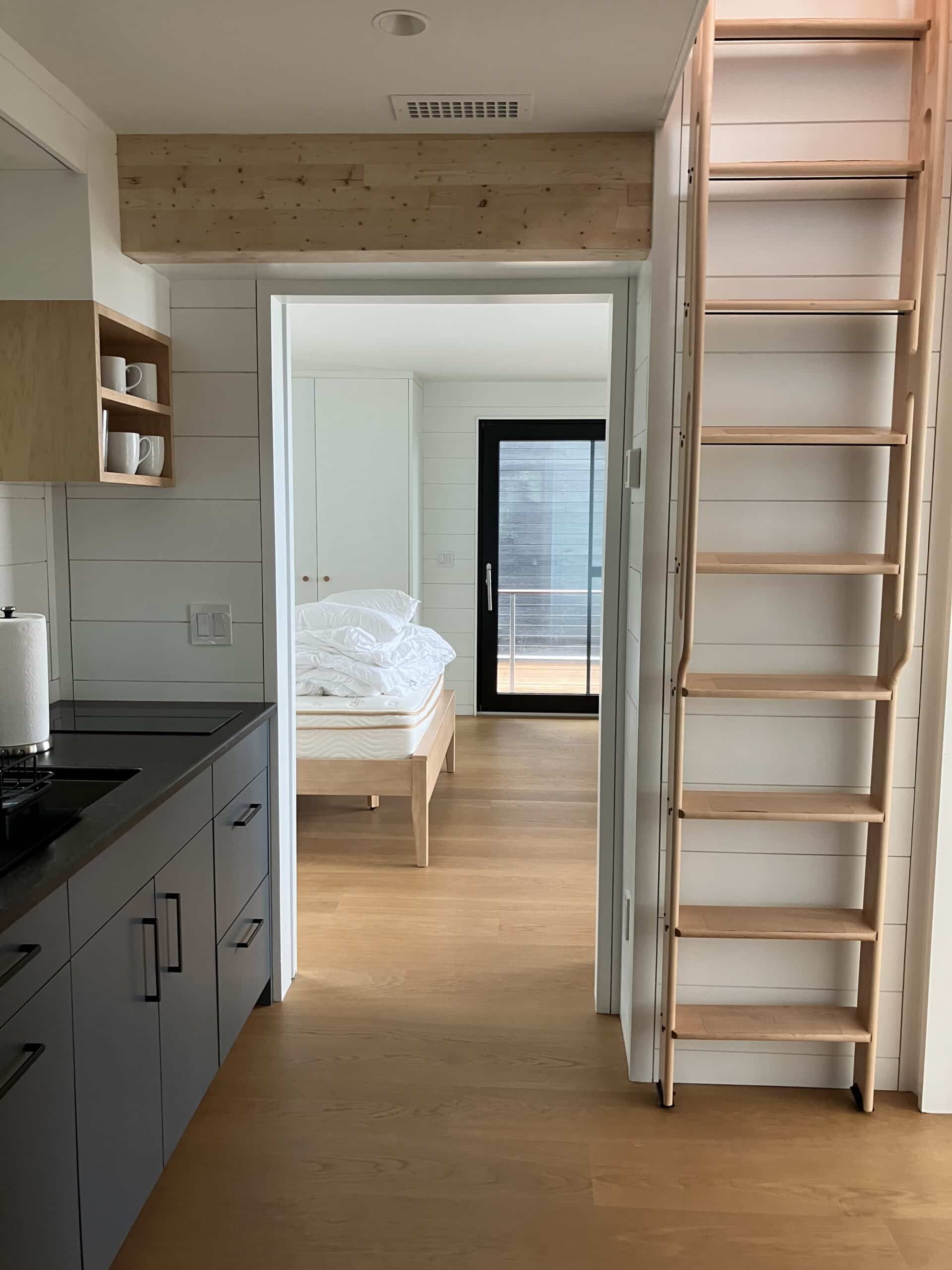 Compact Guest house with small custom kitchen, bedroom and ladder to loft area.