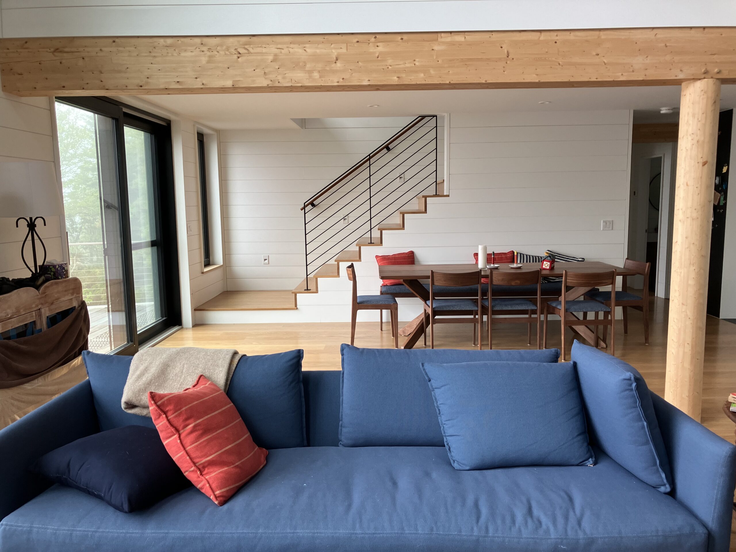 Living room and stairs in a custom Bensonwood house on the coast of Maine.
